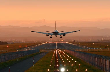 airplane landing in an orange sunset