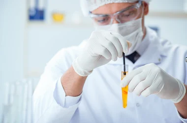 lab tech examining a test tube