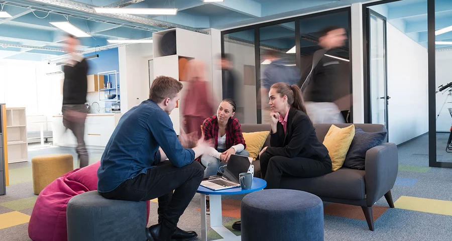En grupp av medarbetare sitter och diskuterar