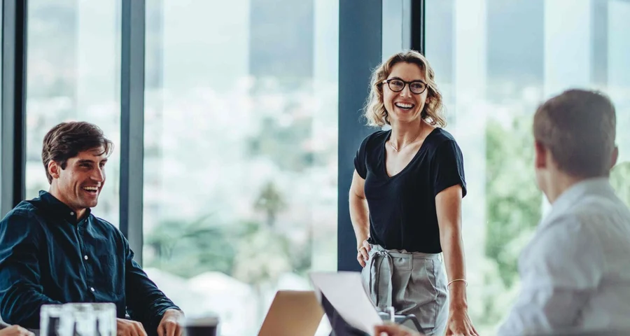 People meeting in board room and smiling