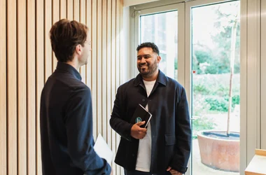 Two men discussing abckground checks and GDPR in a scandinavian office.