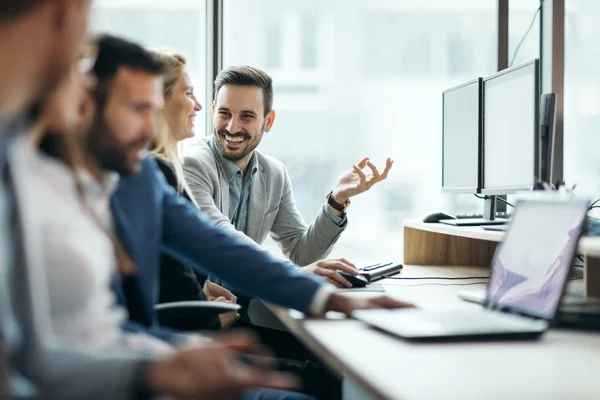 employees smiling and working together