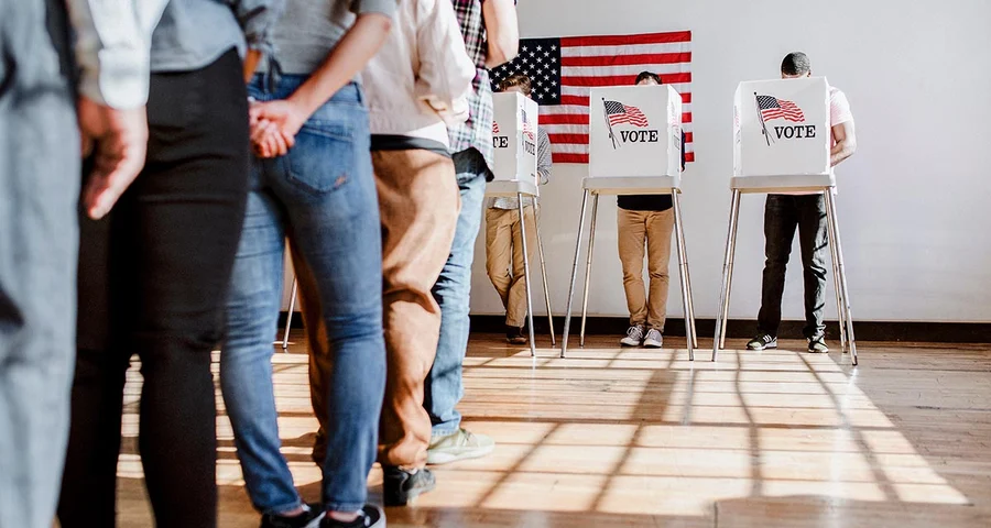 line of people waiting to vote voting booth