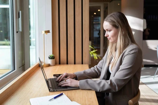 Woman working on laptop at home