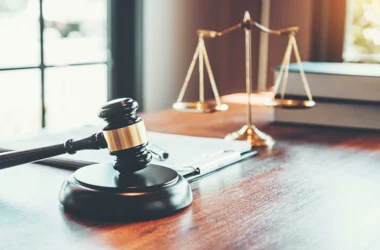 Gavel sitting on a desk with scales of justice